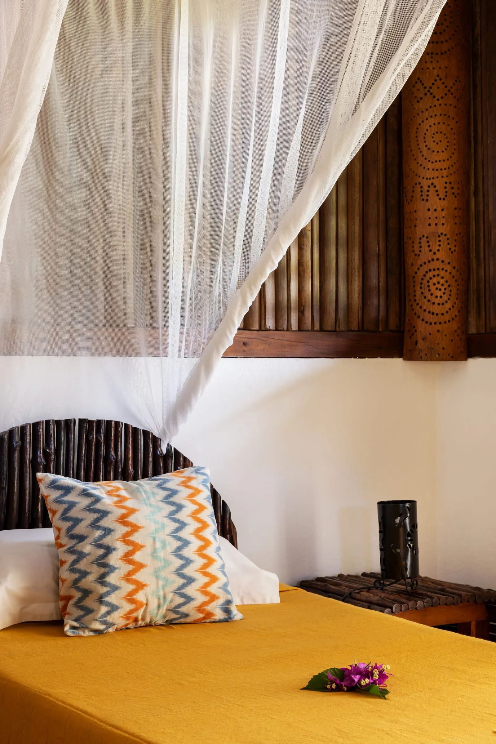 Bed under a mosquito net