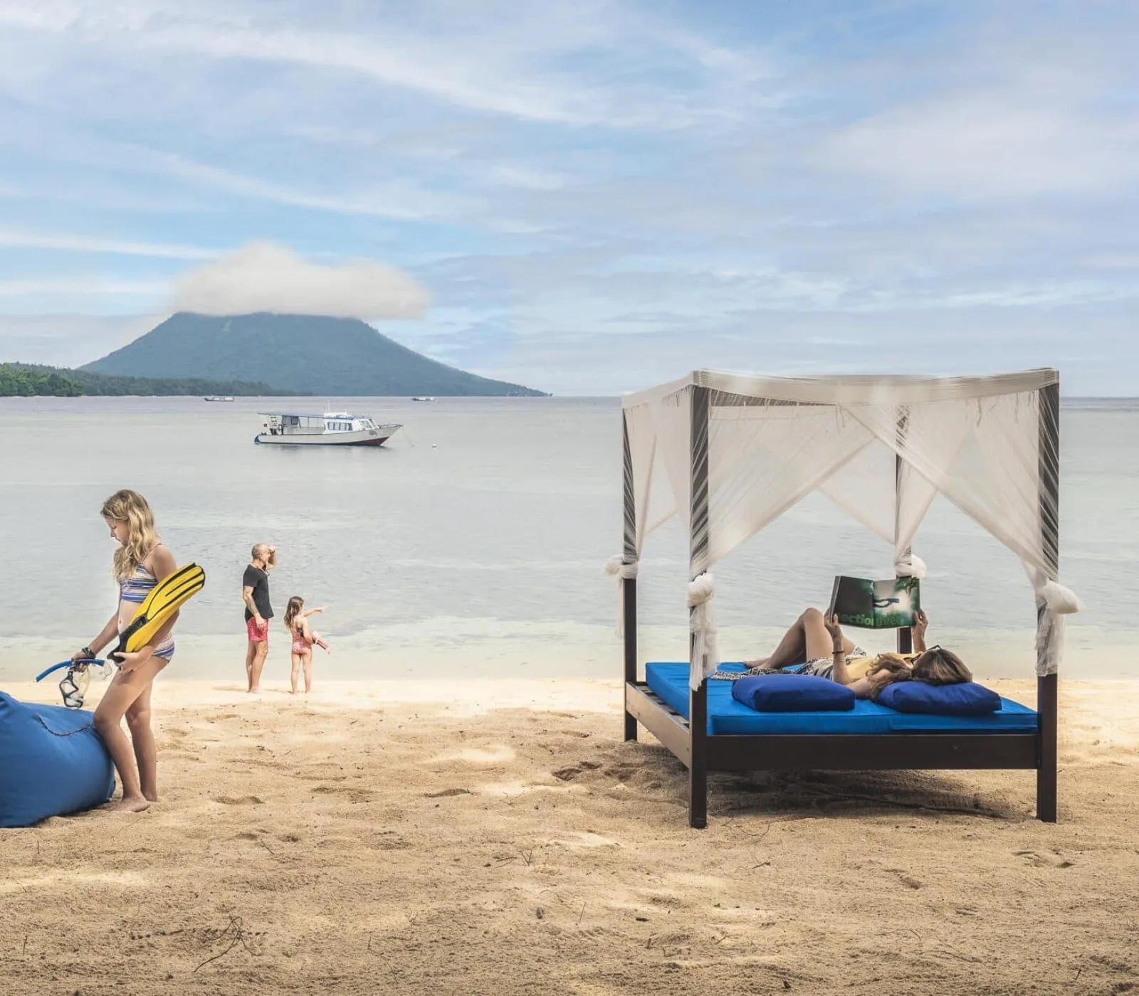 A day bed on the beach with the volcano beyond