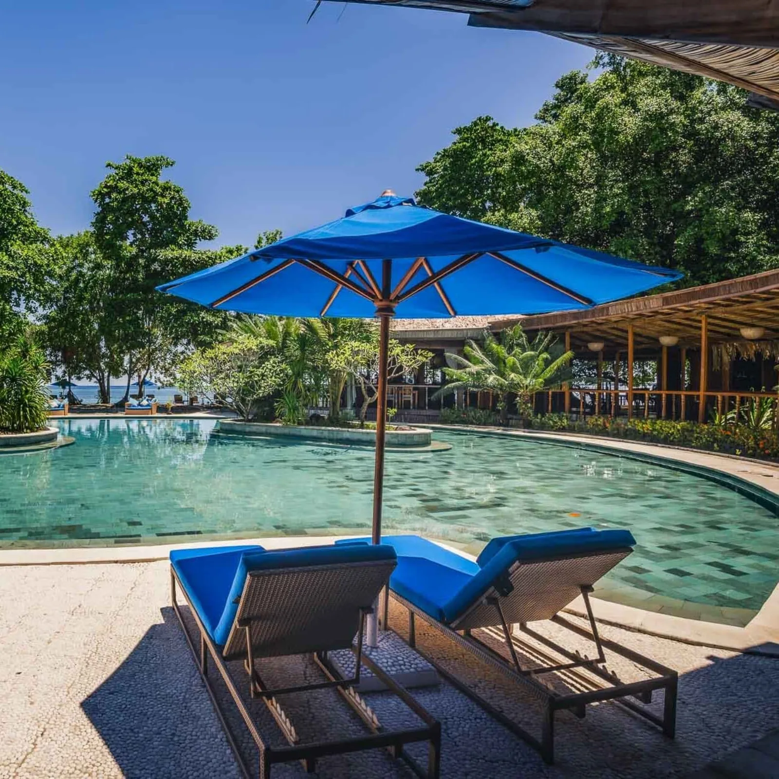 Umbrella and loungers at the pool edge