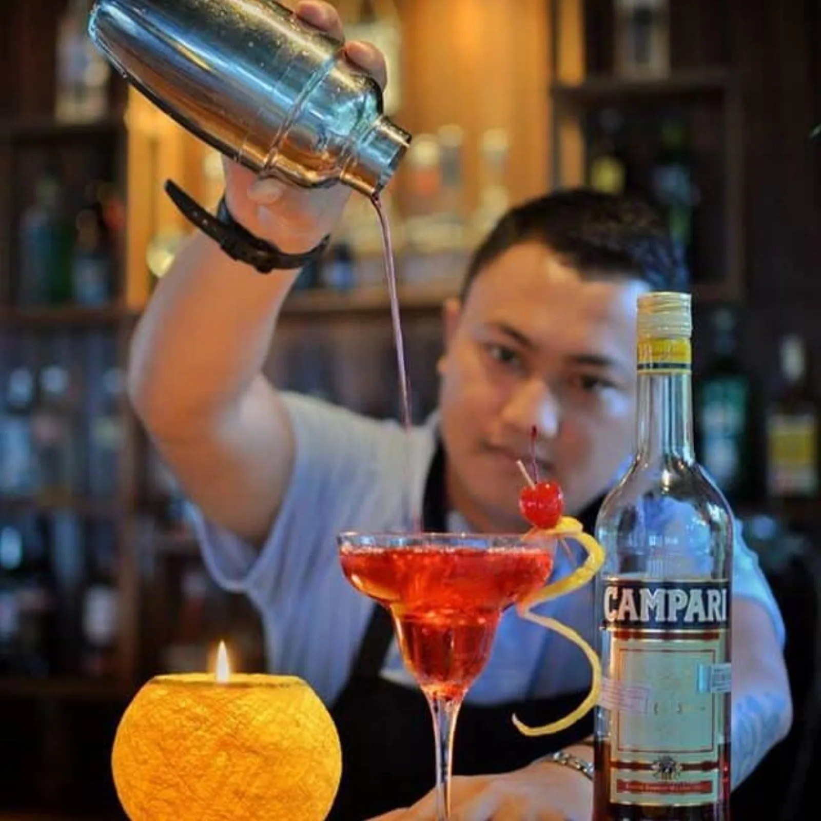 A bartender mixing a cocktail in the lounge bar