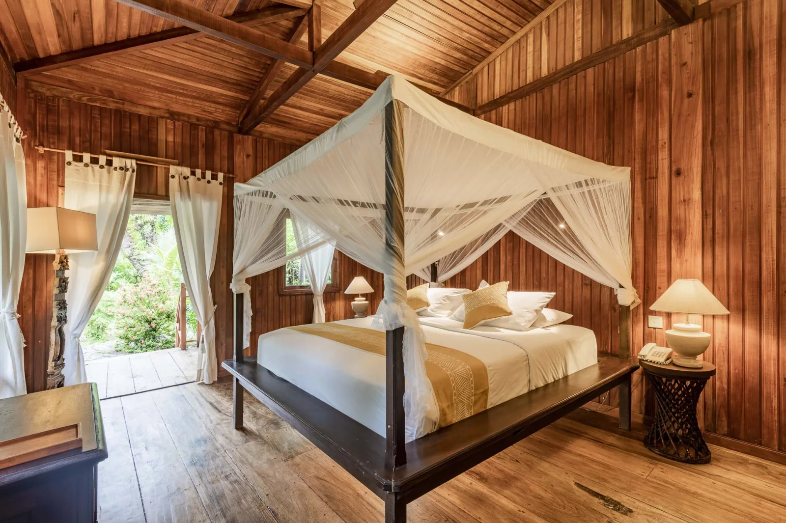 Garden View Villa bedroom with a draped bed