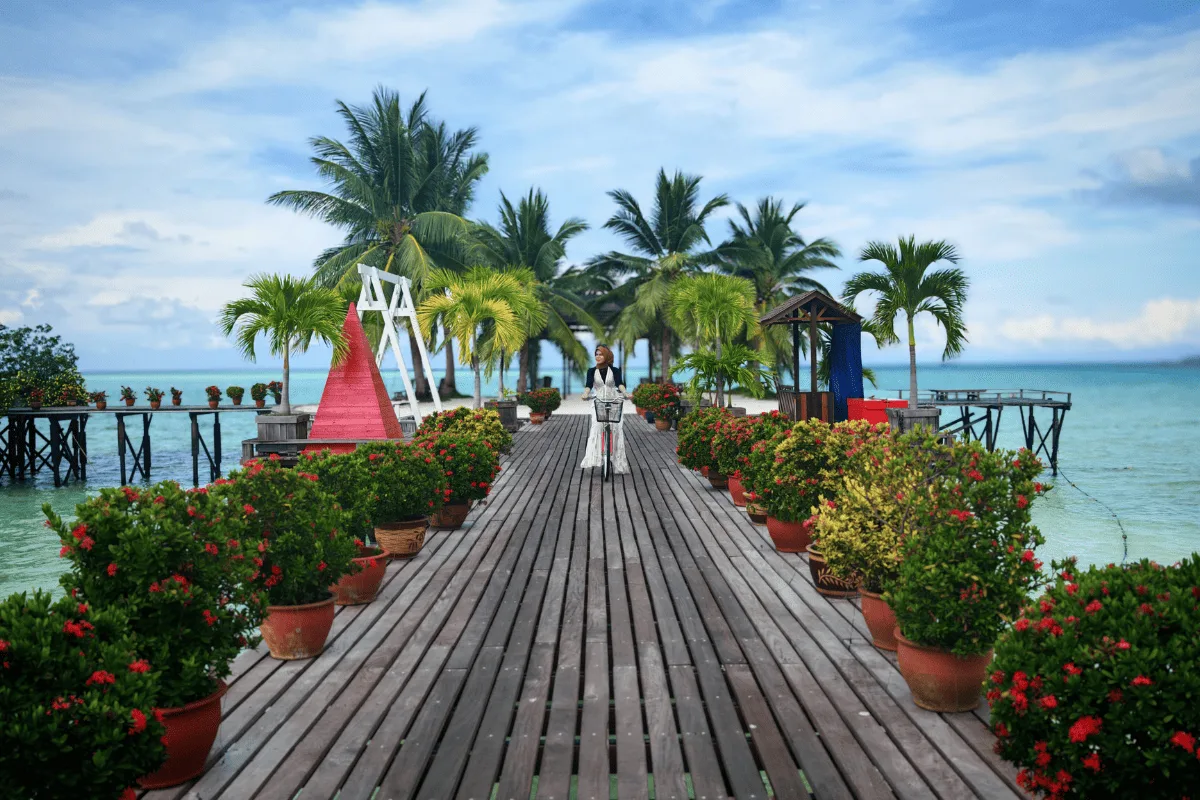 Flower-lined walkway heading out to sea
