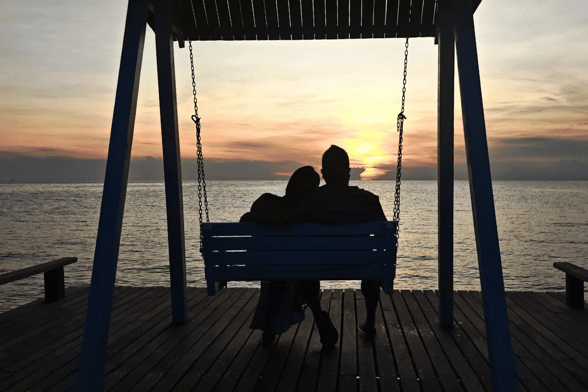 Swing on the walkway against the sunset