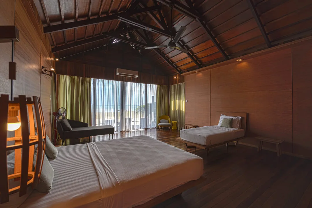 Room with two beds and a balcony door