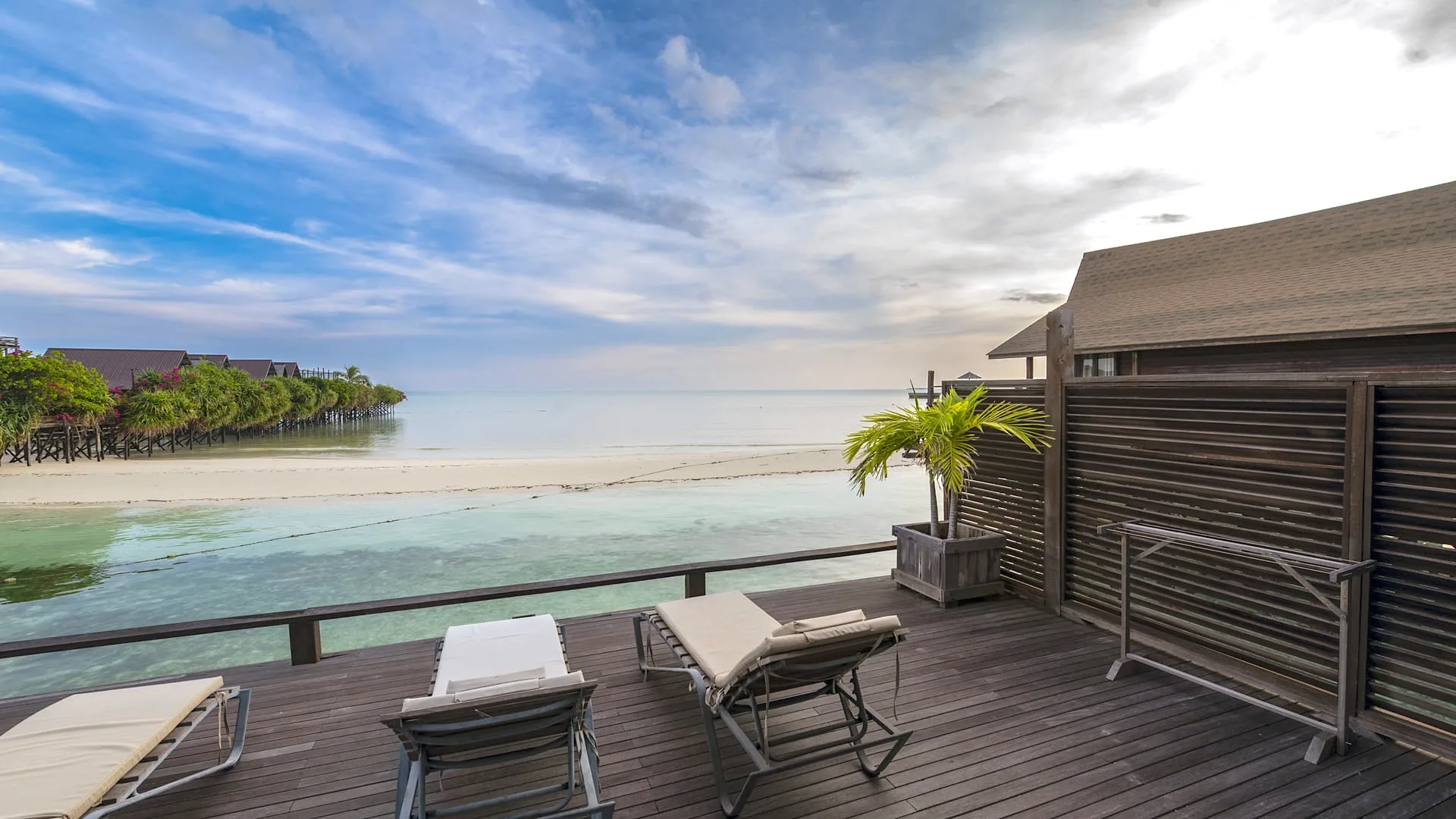 Balcony with loungers above the sandbank