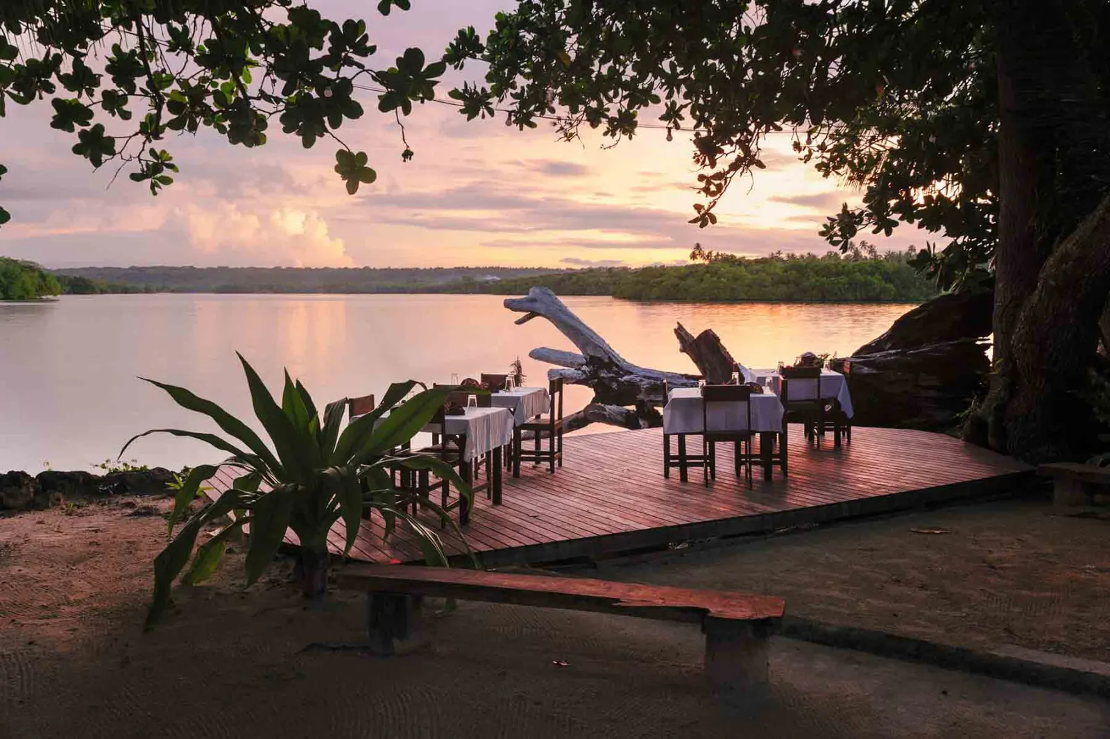 Timber deck over the water at sunset