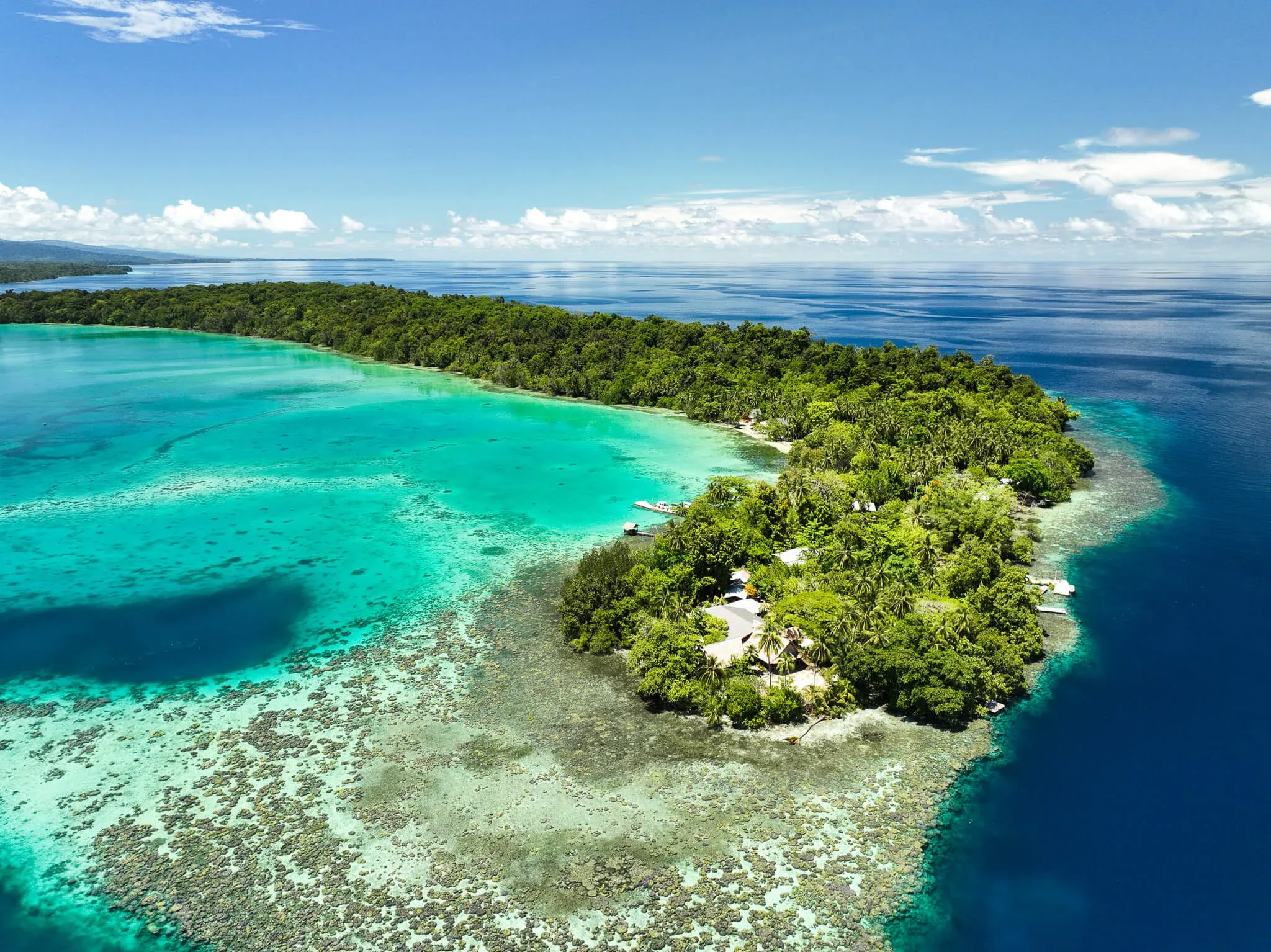Island edge and turquoise shallows from the air